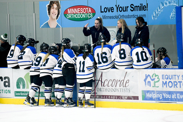 Royals head coach Emily Achterkirch addresses her team from the bench in a recent game.