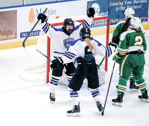 Rogers Royals forwards Anna Scherling and Avery Farrell celebrate after a goal in their Nov. 23 home game against defending state champion Edina. The Hornets prevailed in overtime, 3-2.